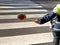 policeman stops the cars on the pedestrian crossing with the pal