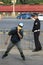 A policeman and a young man on roller skates. Beijing