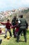 Policemen playing soccer with poor children