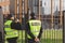 Policemen stand in front of the entrance gate to the house during home intervention