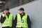 Policemen in vests looking around carefully during patrol in the city center