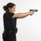 Policewoman aiming gun.