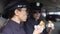 Policewomen on duty having lunch, eating burgers in patrol car, unhealthy diet