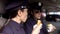 Policewomen on duty having lunch, eating burgers in patrol car, unhealthy diet