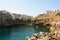 Polignano a mare village on cliff rocks and Mediterranean sea. Overhanging buildings in Apulia town on sea. Italian seascape.