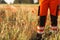 Polish ambulance worker standing in medical orange uniform with reflective elements. Poppy field background.