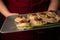 Polish Dumplings on a nice plate held by a waitress