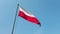 Polish flag, wind and blue sky.