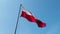 Polish flag, wind and blue sky.