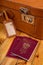 Polish passport and travel suitcase on a wooden table. Accessories for the traveler before the international trip