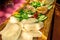 Polish pierogi on wooden board with green salad