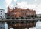 Polish Post Office House in Bydgoszcz. Ancient building above the canal. Red brick building.