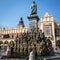 Polish soldiers in the free day posing at the camera near Adam Mickiewicz Monument at the Main Market Square