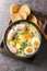 Polish soup zurek with white sausage and eggs close-up in a bowl. Vertical top view