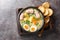 Polish Sour Rye Soup Zurek with white sausage, boiled egg and fresh veggies close-up in a bowl. Horizontal top view