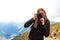 Polish Tatras green hills in summer. Young woman with backpack taking pictures of colorful scenery