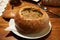 Polish traditional soup Zurek in bread, selective focus