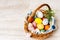 Polish traditional wicker basket full of multi coloured and mottled Easter eggs
