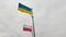 Polish and Ukraine flags waving in the wind. National flag of Poland and Ukraine on cloudy sky