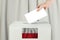 Polish Vote concept. Voter hand holding ballot paper for election vote on polling station