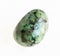 polished african turquoise stone on white