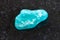 polished amazonite gemstone on dark background