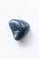 Polished bloodstone gemstone on a white background