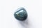 Polished bloodstone gemstone on a white background