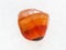 polished carnelian gem stone on white marble