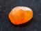 polished Carnelian gemstone on dark background