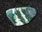 polished Chlorite gemstone on dark background