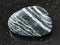 polished Chrysotile asbestos gemstone on dark