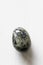 Polished dalmatian jasper gemstone on a white background