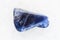 polished Dumortierite gemstone on white marble