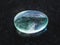 polished Fluorite gemstone on dark background