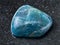 polished green blue Apatite gemstone on dark