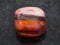 polished jaspilite gem stone on dark background