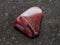 polished jaspilite jasper gemstone on dark