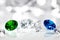 Polished jewels, diamond, blue sapphire and green emerald, brilliant cut