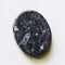 Polished larvikite gemstone on a white background