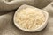 Polished long rice grains in white ceramic bowl