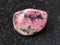 polished pink rhodonite gem stone on dark