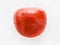 polished red coral gemstone on white marble