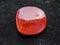 polished red goldstone gemstone on dark