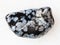 polished snowflake obsidian gem stone on white