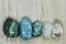 Polished stones malachite azurite turquoise aventurine rock crystal on a wooden background