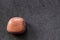 Polished sunstone gemstone on a black background