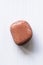 Polished sunstone gemstone on a white background