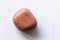 Polished sunstone gemstone on a white background