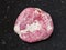 polished Thulite gemstone on dark background